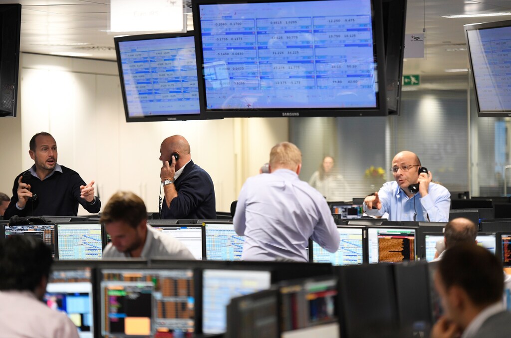Traders at BGC Partners work after Donald Trump won the U.S. Presidential election, in London, Britain, November 9, 2016. REUTERS/Toby Melville - RTX2SQHA