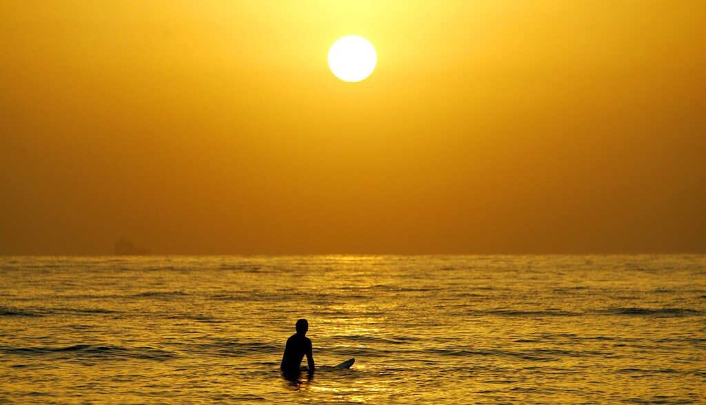 A surfer enjoys a cool surf at sunrise at Sydney's Manly Beach February 19, 2004 as Australia experiences heatwaves from coast to coast. Soaring summer temperatures over 40 degrees Celsius (104 degrees Faharenheit) and tropical-like humidity have left Australians sweltering for the past week, forced zookeepers to cool down animals with blocks of ice and caused power shortages due to a big increase in the use of air-conditioners. NO RIGHTS CLEARANCES OR PERMISSIONS ARE REQUIRED FOR THIS IMAGE REUTERS/Tim Wimborne PP04030068 TBW/FA - RP4DRIGYHYAA