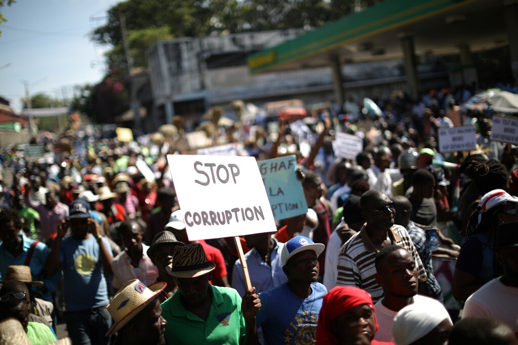 Protesters walk along a street during a march to protest against corruption in Port-au-Prince, Haiti, December 5, 2017. REUTERS/Andres Martinez Casares