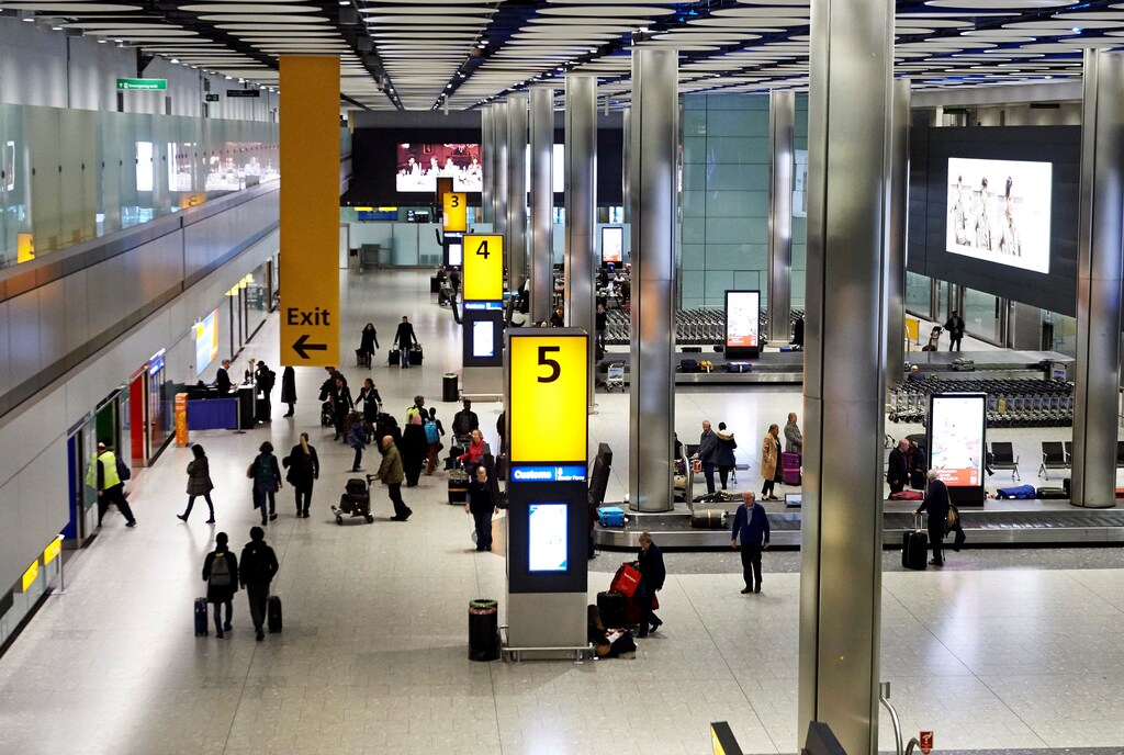 Passengers collect their luggage from the baggage reclaim area of Terminal 5 London Heathrow Airport in west London, Britain, December 19, 2018. Niklas Halle'n/Pool via REUTERS - RC1FA2064C80