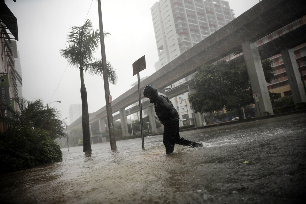 A local resident walks across a flooded street in downtown Miami as Hurricane Irma arrives at south Florida, U.S. September 10, 2017.
