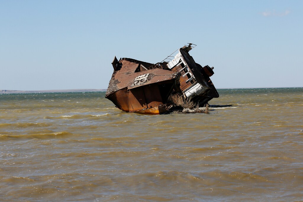A ruined ship lays on the Aral Sea coastline near the village of Akespe, south-western Kazakhstan, environment renewable solar energy change transition friendly environment carbon footprint carbon emissions reduction change natural climate change global warming air pollution clean energy power renewables plastic plastics Weather extreme storm hurricane typhoon flooding flood floods danger rain wind windy rainy flash floods