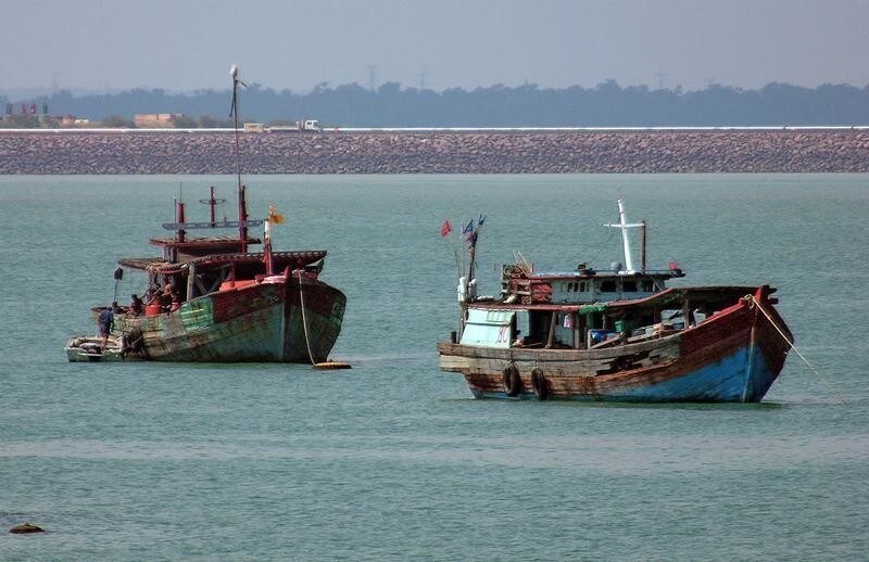 A man boards an impounded illegal fishing vessel moored at the northern city of Darwin in this picture taken May 11, 2005. Australia has spent tens of millions of dollars boosting its border security to deal with Indonesian fishermen venturing into Australian waters to fish for lucrative shark fin because they have depleted their own stocks. Picture taken May 11, 2005. To match feature Australia-Fishing REUTERS/David Gray - RP2DSFHPKVAA
