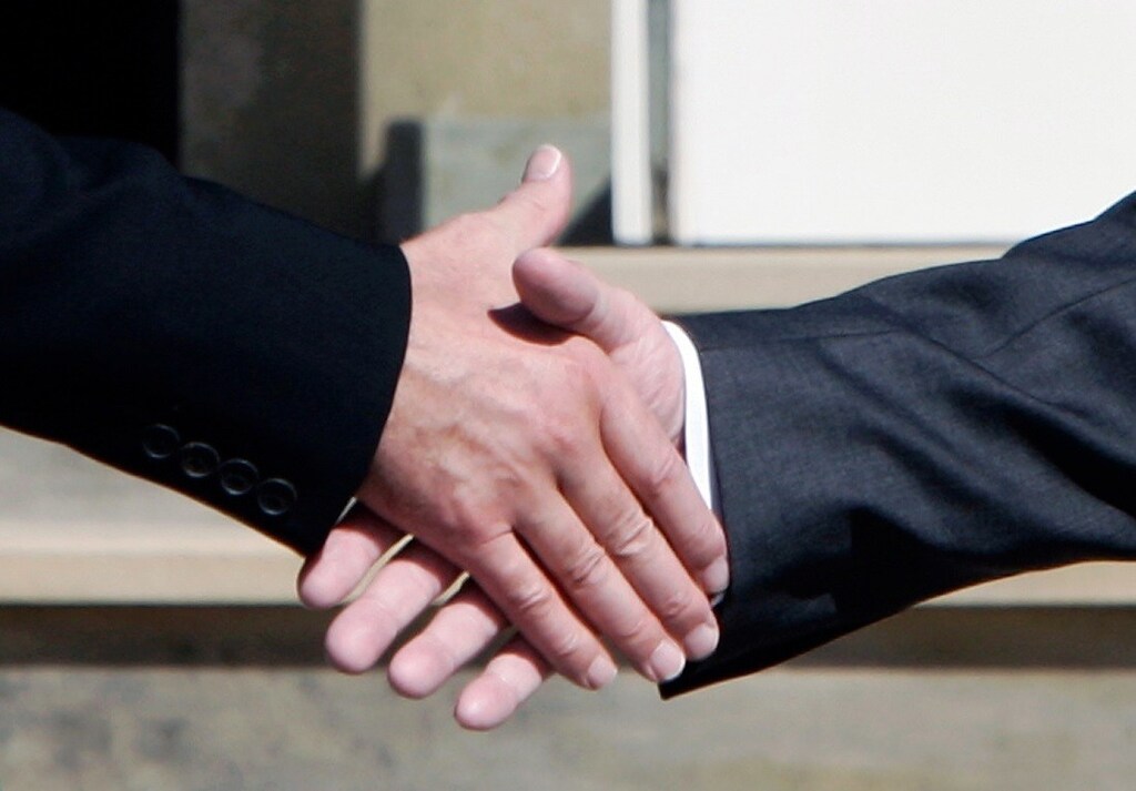 British Prime Minister Tony Blair (L) shakes hands with German Chancellor Gerhard Schroeder at the Gleneagles Hotel for the G8 summit in Gleneagles, Scotland July 7, 2005. Aid, debt relief and climate change will top the agenda when leaders of the G8 - the Group of Seven industrialised nations plus Russia - meet for three days in Gleneagles. UNICS REUTERS/Jim Young CRB - RTRGQCN