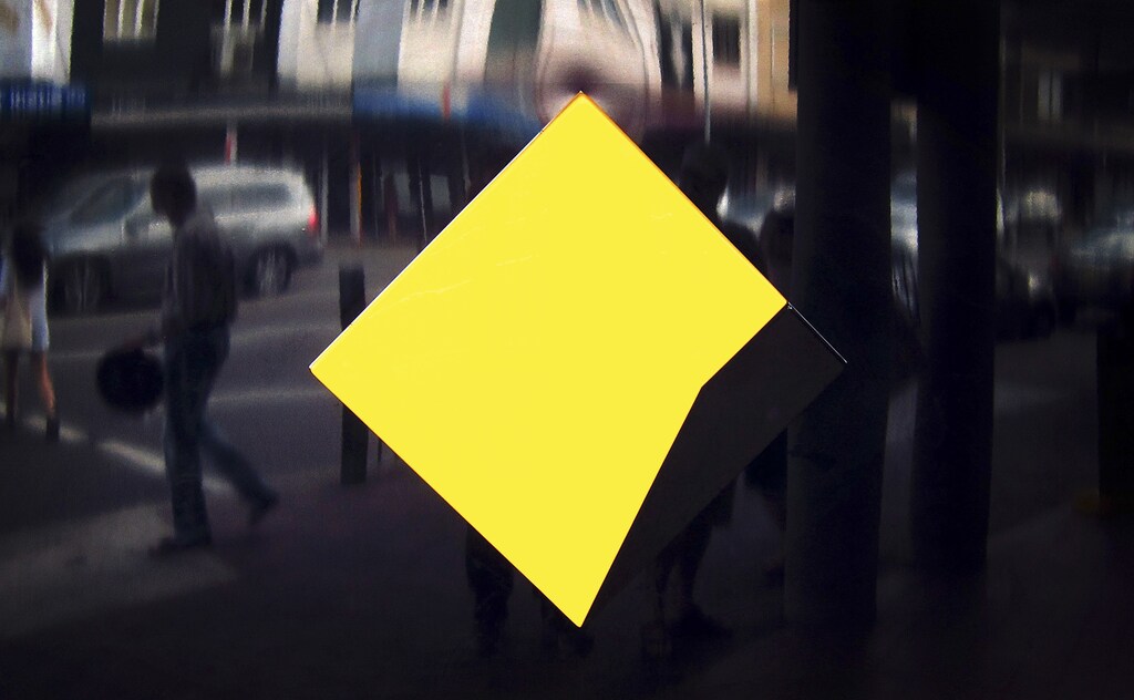 Pedestrians are reflected near a Commonwealth Bank of Australia logo outside a small branch located in a suburb of Sydney February 11, 2015. Commonwealth Bank of Australia , the country's No.1 lender by market value, posted record profit for the first half of the current financial year ending June and boosted its interim dividend, helped by higher credit growth and lower bad debt charges. CBA posted cash profit of A$4.62 billion ($3.59 billion) for the six months ended December compared with consensus forecast of A$4.5 billion from eight analysts polled by Reuters and up from A$4.27 billion a year ago. REUTERS/David Gray (AUSTRALIA - Tags: BUSINESS LOGO) - RTR4P2W9