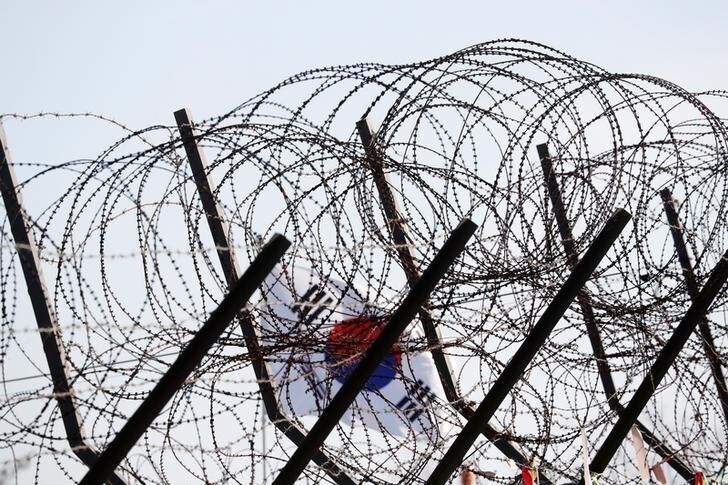 A South Korean national flag flutters in the wind behind a barbed wire fence near the demilitarised zone separating the two Koreas in Paju, South Korea, November 29, 2017. REUTERS/Kim Hong-Ji