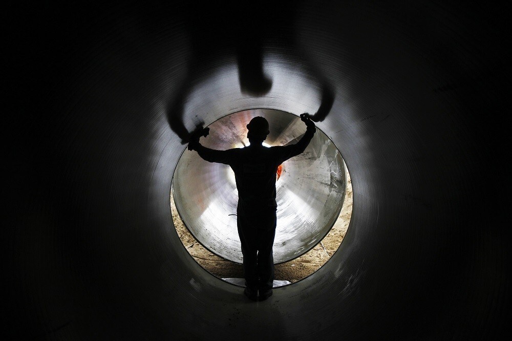 A worker helps put together a pipeline during the construction of the Olmos Irrigation Project in Peru's northwestern region of Lambayeque, March 15, 2013. The Olmos Irrigation Project next year will start pumping billions of gallons of water onto a nearby 170
