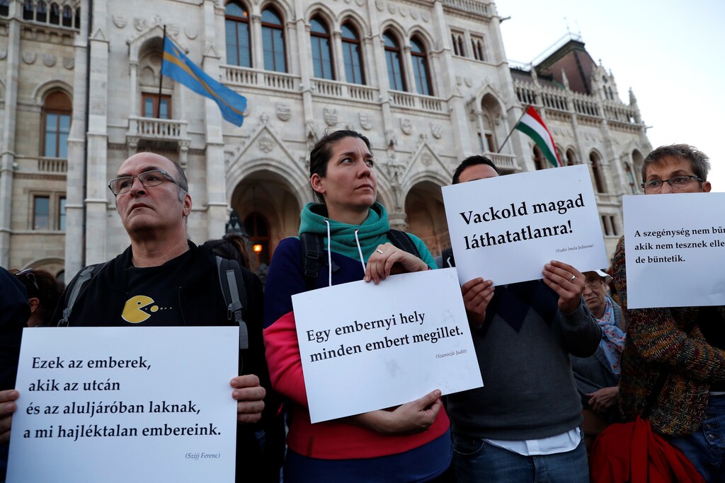 Civilians attend a demonstration in support of the homeless in front of the Hungarian Parliament in Budapest, Hungary, October 14, 2018. Picture taken October 14, 2018. REUTERS/Bernadett Szabo - RC1E25CAAD40