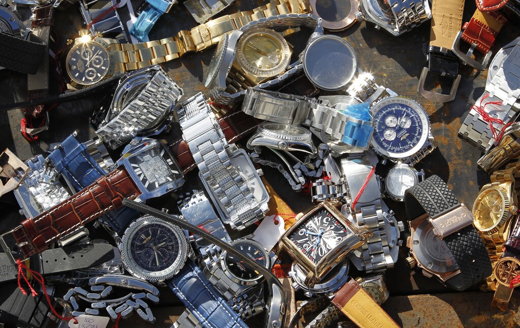 Several thousand fake Swiss watches, confiscated by Swiss customs throughout 2010, are laid out on the ground ready to be destroyed, at the Bern-Belp airport in Bern October 28, 2010.