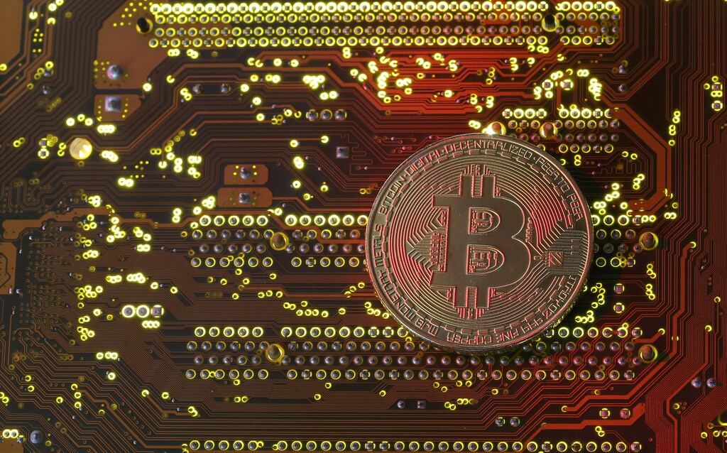 A copy of bitcoin standing on PC motherboard is seen in this illustration picture, October 26, 2017. Picture taken October 26, 2017. REUTERS/Dado Ruvic - RC1B7D9AB540