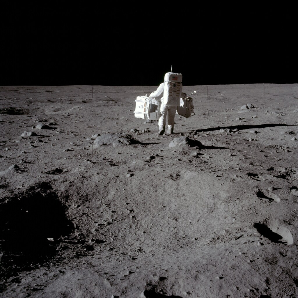 Apollo 11 lunar module pilot Buzz Aldrin carries equipment for the Passive Seismic Experiments (in his left hand) and the Laser Ranging Retroreflector (in his right) to the deployment area at Tranquility Base in the Sea of Tranquility on the moon, July 20, 1969. Neil Armstrong/NASA/Handout via REUTERS ATTENTION EDITORS - THIS IMAGE HAS BEEN SUPPLIED BY A THIRD PARTY. - RC1775AC2200