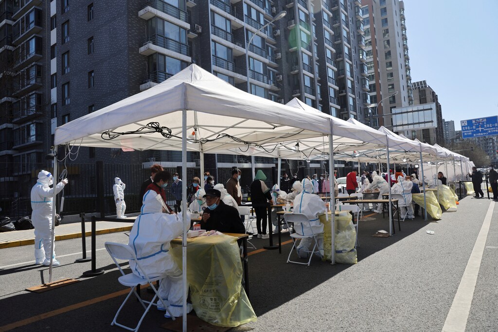 Residents line up during a mass testing for COVID-19 in Chaoyang district of Beijing, China.