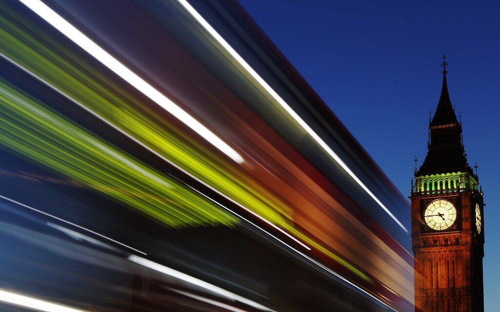 Light trails shine from a passing bus in front of Big Ben and the Houses of Parliament in London, November 17, 2011. REUTERS/Luke MacGregor (BRITAIN - Tags: POLITICS TRAVEL) - LM1E7BH1DL001