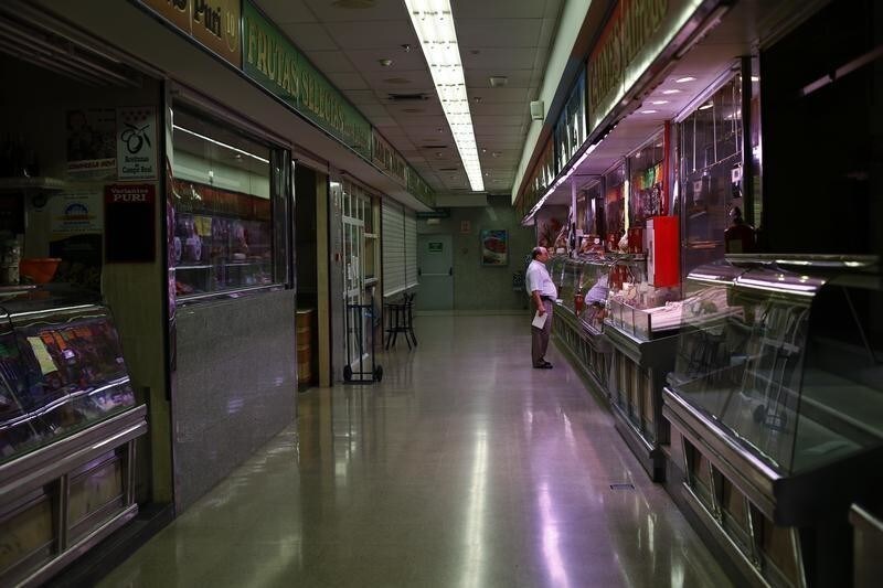 A man shops at a butcher's store in a local market in Madrid September 4, 2012. As of September 1, Spain's VAT tax rate surged to 21% on a range of goods and services as part of a government plan to boost revenues and cut the deficit and avoid a full-blown European bailout. Cash-strapped Spanish consumers and small business owners adjust to a higher value-added tax imposed to cut the public deficit while the country's second recession in three years drags on. REUTERS/Susana Vera (SPAIN - Tags: BUSINESS SOCIETY) - GM1E8941OGC01