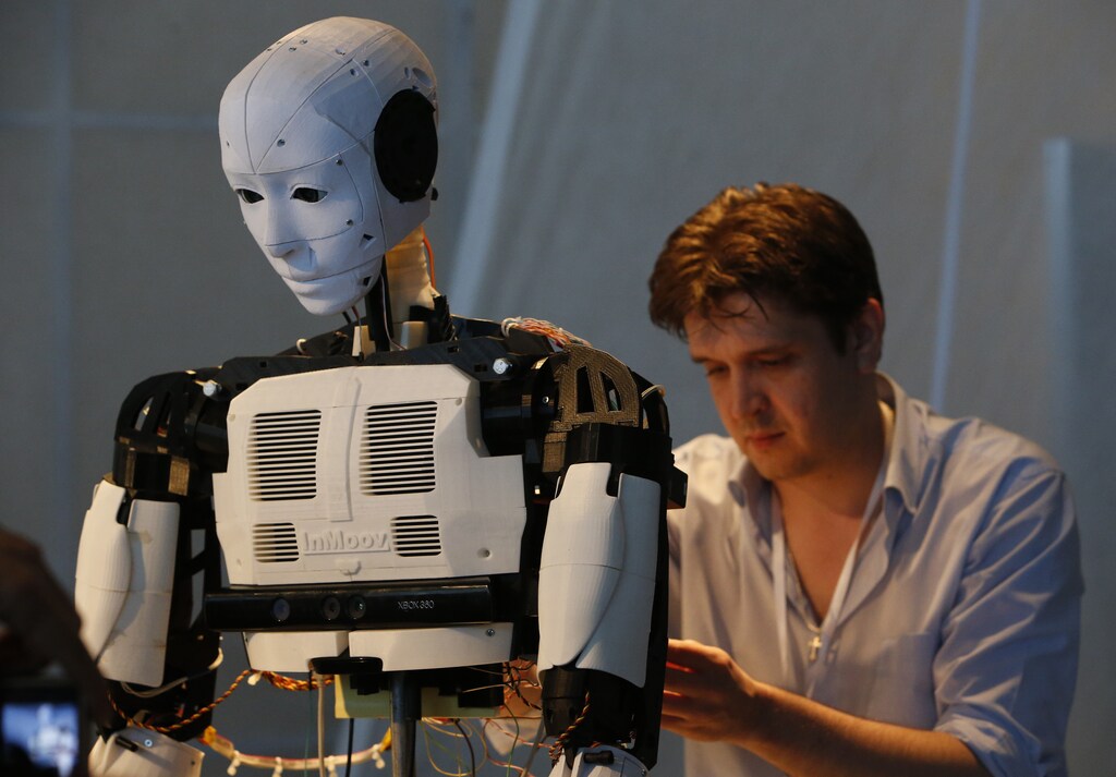 A technician makes adjustments to the "Inmoov" robot from Russia during the "Robot Ball" scientific exhibition in Moscow May 17, 2014. Picture taken May 17, 2014.