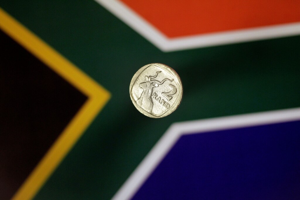 Illustration photo shows a two-rand coin above a South Africa flag April 12, 2017. REUTERS/Thomas White/Illustration - RC16482C97B0