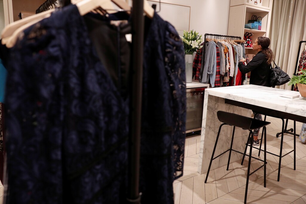 A woman looks at clothes at the Rent The Runway store, an online subscription service for women to rent designer dress and accessory items, in New York City, New York, U.S., September 12, 2019. Picture taken September 12, 2019. REUTERS/Shannon Stapleton - RC16BAFFCC50