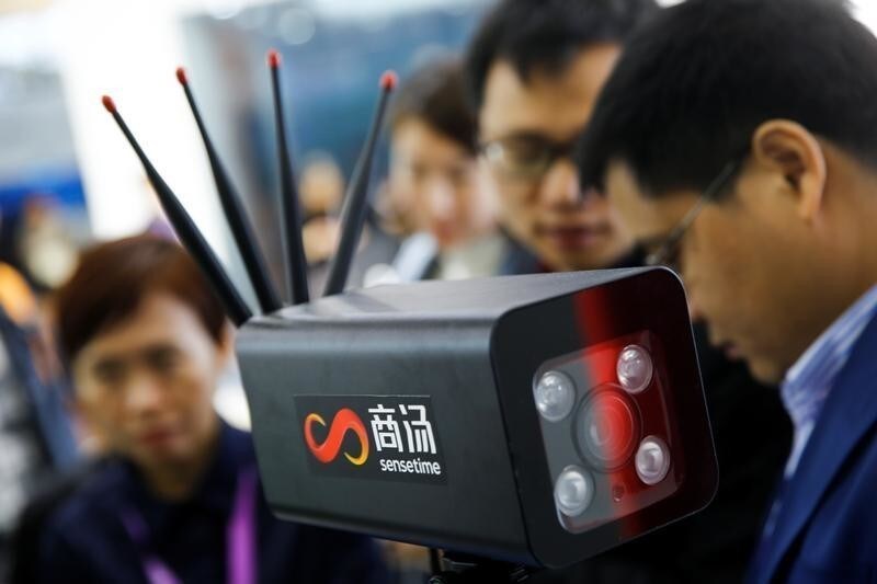 Visitors surround a camera at the stall of the artificial intelligence and facial recognition technology company Sensetime at the Security China 2018 exhibition on public safety and security in Beijing, China October 23, 2018.