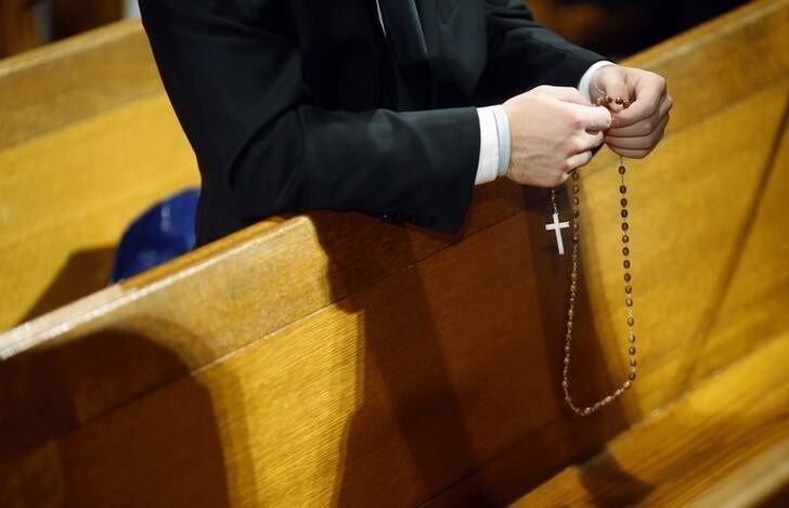 Seminarian Mark Mergner prays the rosary as he awaits Pope Francis' arrival at the Basilica of the National Shrine of the Immaculate Conception in Washington September 23, 2015. REUTERS/Patrick Semansky/Pool