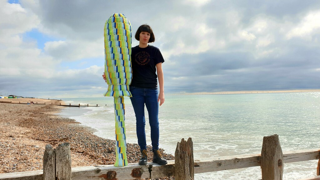 Ella Daish with a giant tampon applicator made from discarded plastic applicators found on British beaches