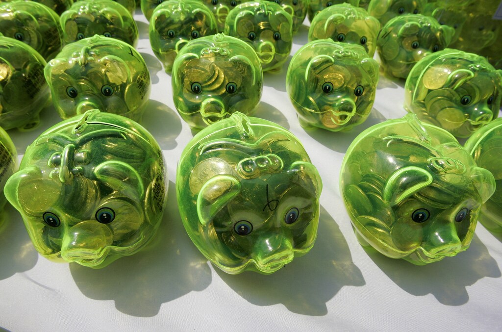 Piggy banks filled with money are displayed on a desk during a "Save our economy" campaign by Korea Saemaulundong Centre in Seoul April 7, 2009. The piggy banks were distributed to people by the centre and re-collected with donations to help the unfortunate who are suffering due to the global economy crisis. REUTERS/Jo Yong-Hak (SOUTH KOREA BUSINESS SOCIETY) - GM1E54711KB01