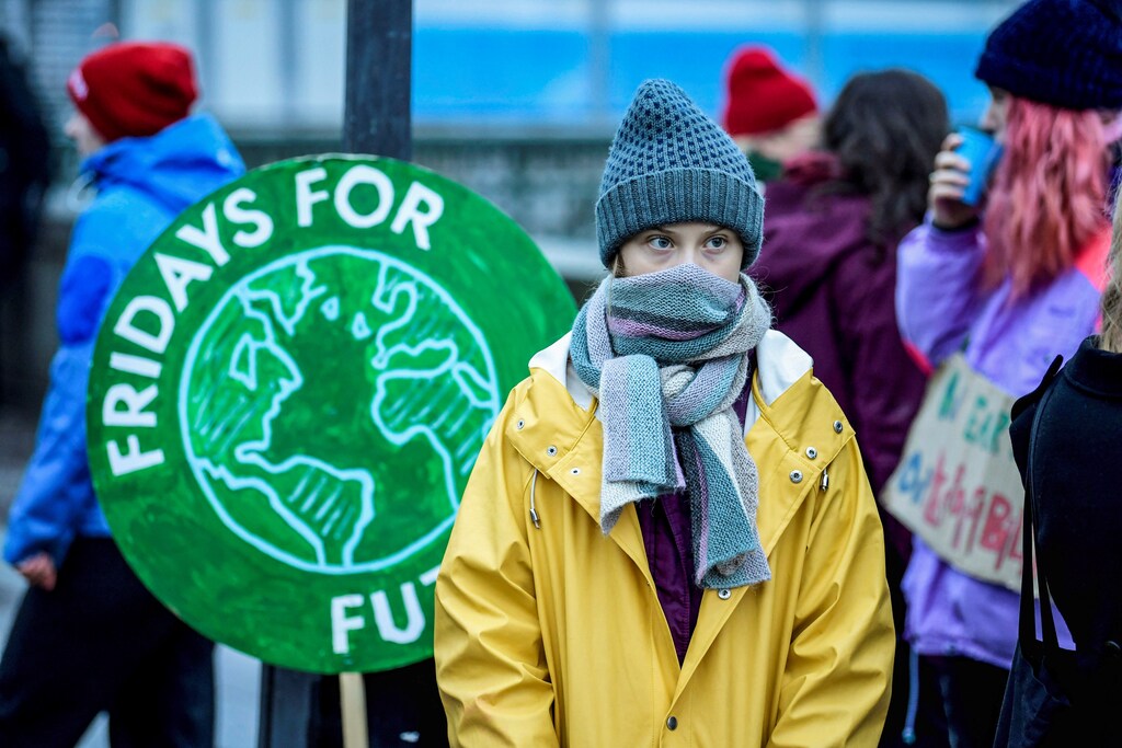 Swedish environmental activist Greta Thunberg attends a climate strike of the "Fridays For Future" movement outside the Swedish parliament Riksdagen in Stockholm, December 20, 2019. TT News Agency/Pontus Lundahl via REUTERS greta thunberg no one is too small to make a difference environment renewable solar energy change transition friendly environment carbon footprint carbon emissions reduction change natural climate change global warming air pollution clean energy power renewables plastic plastics