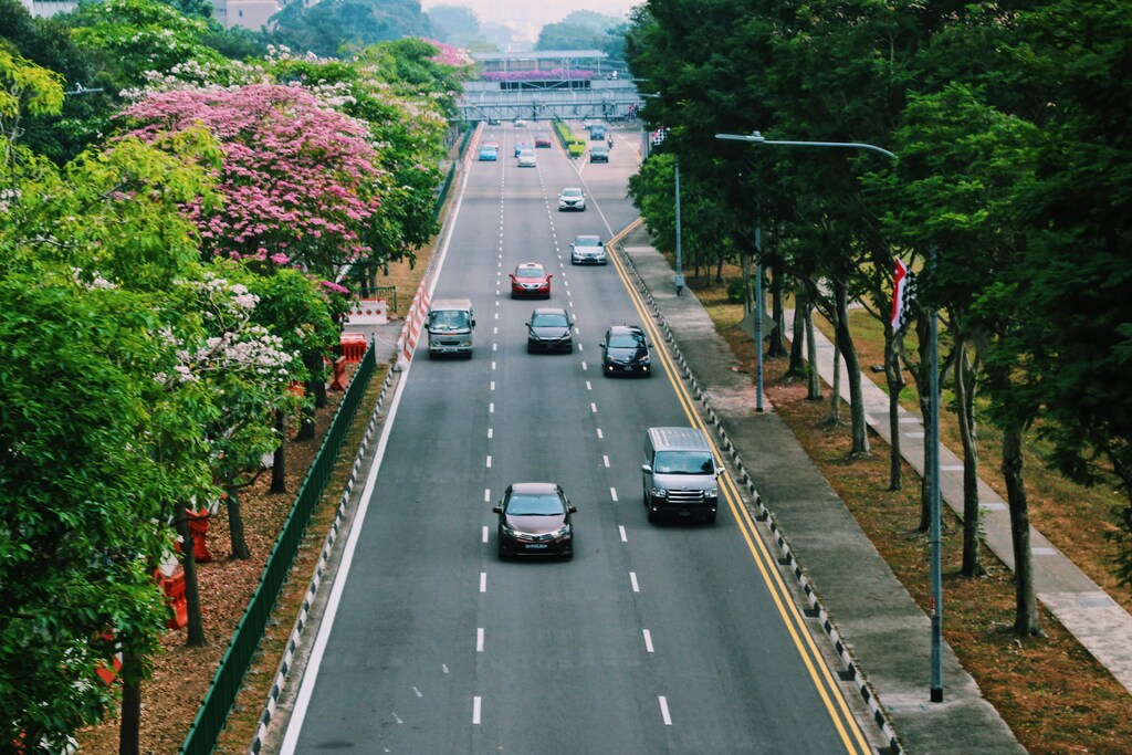 Cars driving down a road.