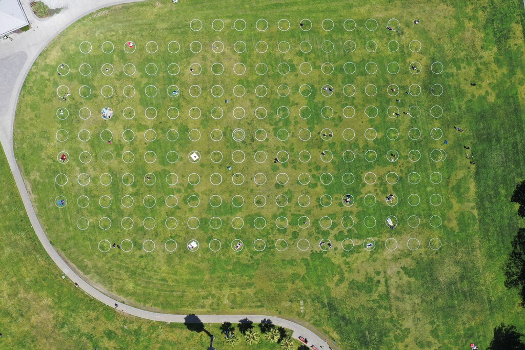 Sunbathers lie in circles marked on the grass to aid in social distancing, to help slow the spread of coronavirus disease (COVID-19) at Mission Dolores Park in San Francisco, California, U.S. May 21, 2020. REUTERS/Drone Base - RC29TG9BY8ZQ