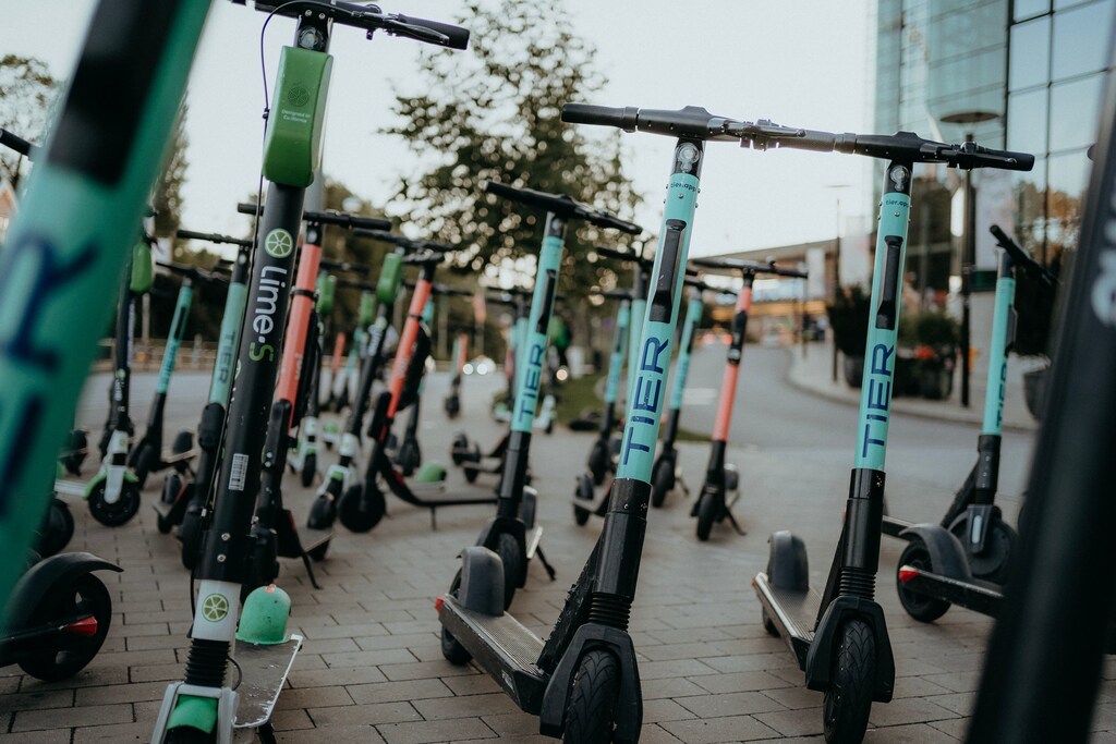Electric scooters parked on sidewalk: Electric vehicles could help curb mobility emissions.