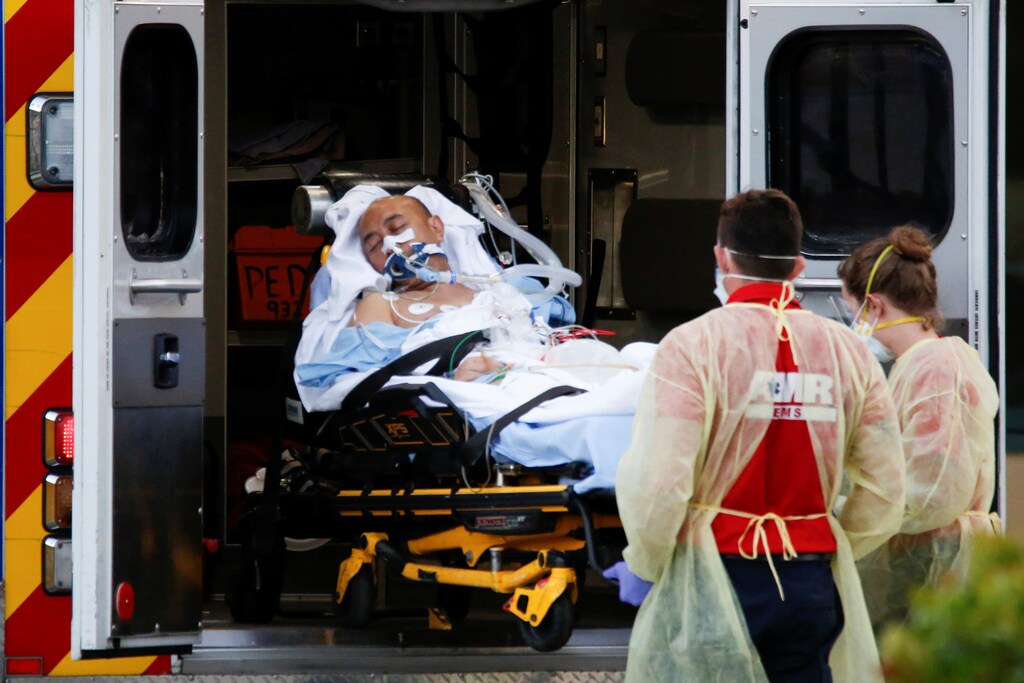 Rescue workers push a stretcher with a patient from the Zaandam of the Holland America Line cruise ship, afflicted with coronavirus disease (COVID-19), at Broward Heatlh Medical Center in Fort Lauderdale, Florida, U.S., April 2, 2020. REUTERS/Marco Bello - RC2NWF9S6JGJ