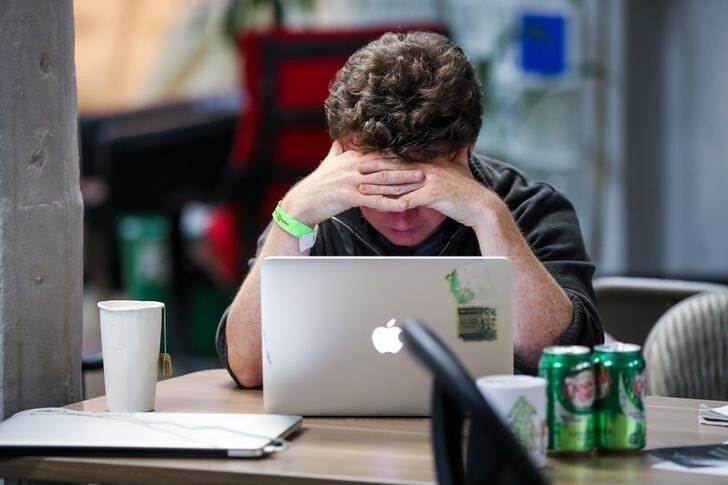 A young man works at his Apple computer during a weekend Hackathon event in San Francisco, California, U.S., July 16, 2016. REUTERS/Gabrielle Lurie