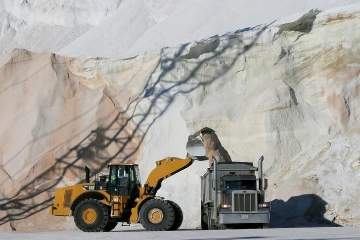 Crews load de-icing road salt onto trucks, in preparation for a winter storm, at Eastern Salt Company in Chelsea, Massachusetts, U.S., January 3, 2018. REUTERS/Brian Snyder