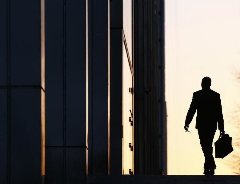 A worker arrives at his office in the Canary Wharf business district in London February 26, 2014. London's financial services sector created 25 percent more jobs in February than a year ago, new data has shown, indicating the industry may be recovering from the restructuring and redundancies prompted by the financial crisis. After a strong January, the City hiring market showed no signs of slowing down last month, with 3,220 new jobs created, compared with 2,575 added in February 2013, according to financial services recruiter Astbury Marsden. The data suggests London's banks and financial services companies are returning to growth after slashing thousands of jobs in the face of a lengthy recession and a series of industry scandals that followed the financial crisis. Picture taken February 26, 2014. REUTERS/Eddie Keogh (BRITAIN - Tags: BUSINESS EMPLOYMENT TPX IMAGES OF THE DAY)
