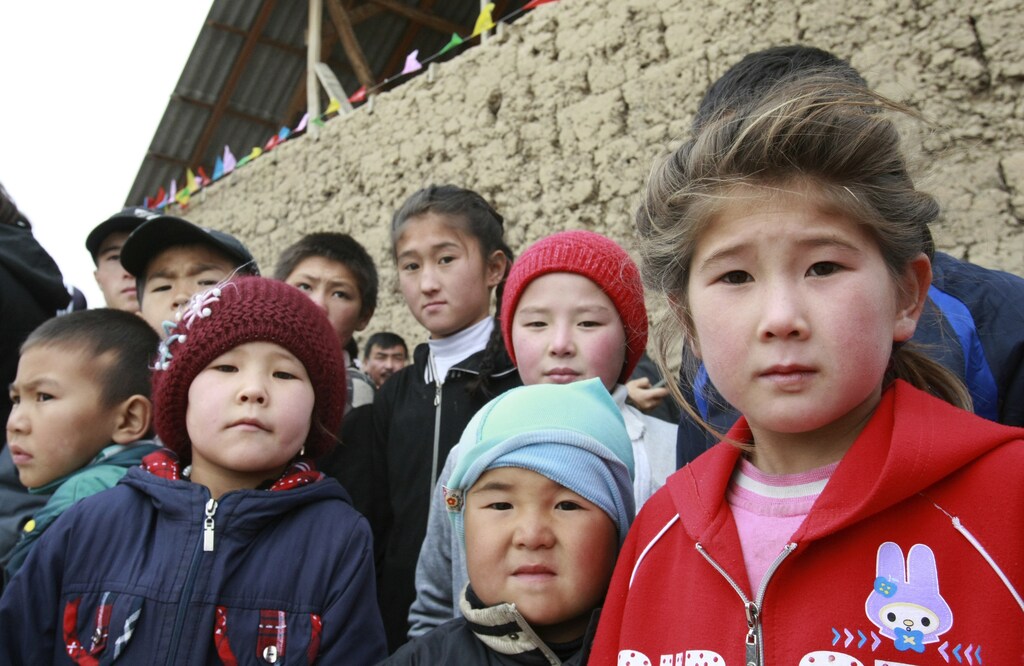Children wait for a meeting with Kyrgyzstan's Prime Minister and presidential candidate Almazbek Atambayev, who is taking part in his election campaign, in Ak-Zhar district, on the outskirts of the capital Bishkek October 27, 2011. Twenty candidates will vie for the presidency of Kyrgyzstan in an October 30 election -- the final stage of constitutional reforms designed to turn the country into Central Asia's first parliamentary republic.