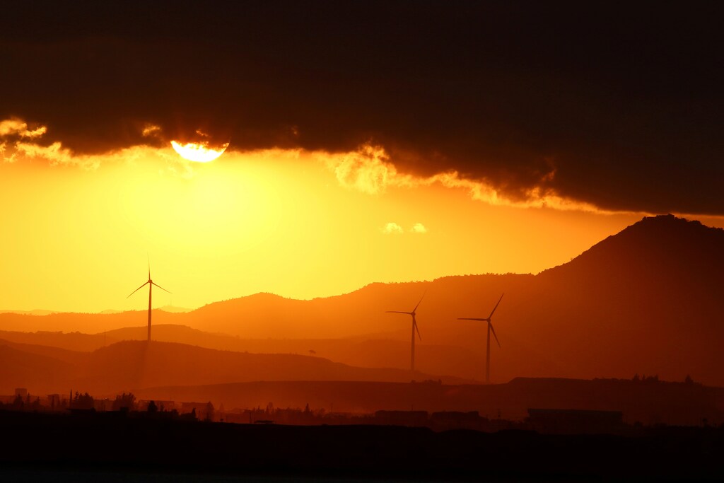 Power-generating windmill turbines are pictured during the sunset near Larnaca, Cyprus September 30, 2017.