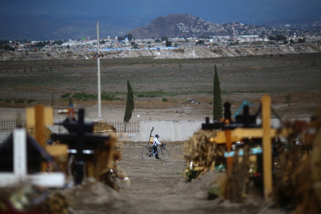 A musician known as "El Gorrion" leaves from Xico cemetery after a day of work on the outskirts of Mexico City, as the coronavirus disease (COVID-19) outbreak continues in Mexico, June 26, 2020. REUTERS/Edgard Garrido - RC2DHH9CP2QZ