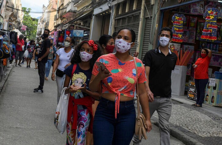 People wear protective masks as they walk at a popular shopping street, as the city eases restrictions and allows commerce to open, amid the coronavirus disease (COVID-19) outbreak in Rio de Janeiro, Brazil June 29, 2020.
