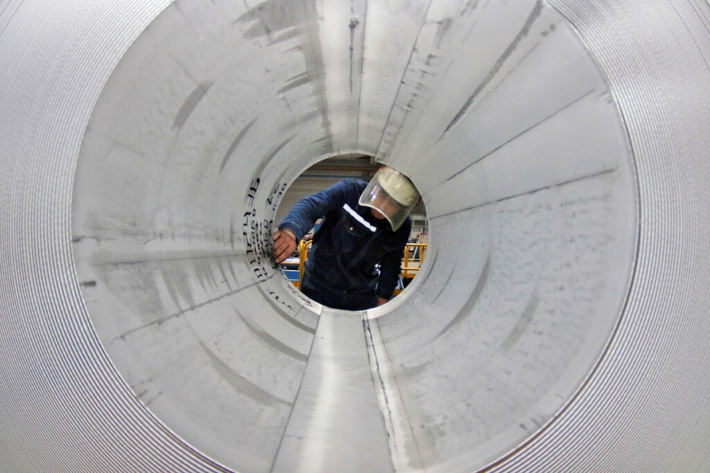 An employee works at the production line of aluminium rolls at a factory in Zouping, Shandong province, China November 23, 2019.