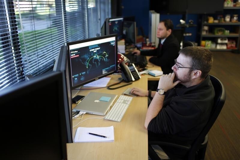 FireEye information analysts work at the company's office in Milpitas, California, December 29, 2014. FireEye is the security firm hired by Sony to investigate last month's cyberattack against Sony Pictures. Picture taken December 29. REUTERS/Beck Diefenbach (UNITED STATES - Tags: BUSINESS SCIENCE TECHNOLOGY CRIME LAW) - GM1EB1200PY01