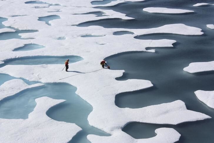 The crew of the U.S. Coast Guard Cutter Healy, in the midst of their ICESCAPE mission, retrieves supplies in the Arctic Ocean in this July 12, 2011 NASA handout photo. Kathryn Hansen/NASA via REUTERS/File Photo ATTENTION EDITORS - THIS IMAGE WAS PROVIDED BY A THIRD PARTY. EDITORIAL USE ONLY.