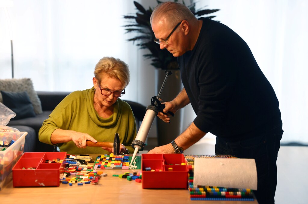 Rita Ebel (L), nicknamed "Lego grandma", and her husband Wolfgang build a wheelchair ramp from donated Lego bricks in the living room of their flat in Hanau, Germany, February 17, 2020. Picture taken February 17, 2020. Ebel started to build the ramps almost one year ago to raise awareness for handicapped people in her hometown of Hanau. Meanwhile, dozens of stores use the ramps to ease entry for wheelchair users. REUTERS/Kai Pfaffenbach - RC2X2F9FM86I