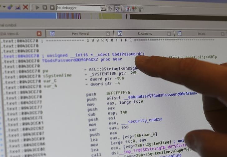 Cybersecurity researcher Billy Rios points to a computer line reading "Gods Password," a password he was able to uncover by analyzing the software in a Pyxis medical supply dispenser that he says he purchased on Ebay for a few hundred dollars, in Redwood City, California October 10, 2014. Picture taken October 10, 2014. To match Insight CYBERSECURITY-MEDICALDEVICES/ REUTERS/Robert Galbraith (UNITED STATES - Tags: SCIENCE TECHNOLOGY HEALTH)