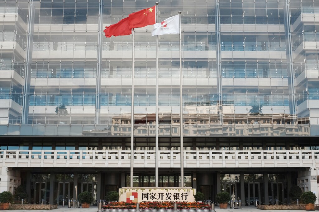 A Chinese flag (C) flutters at the headquarters of China Development Bank (CDB) in Beijing, China September 23, 2018. Picture taken September 23, 2018. REUTERS/Florence Lo