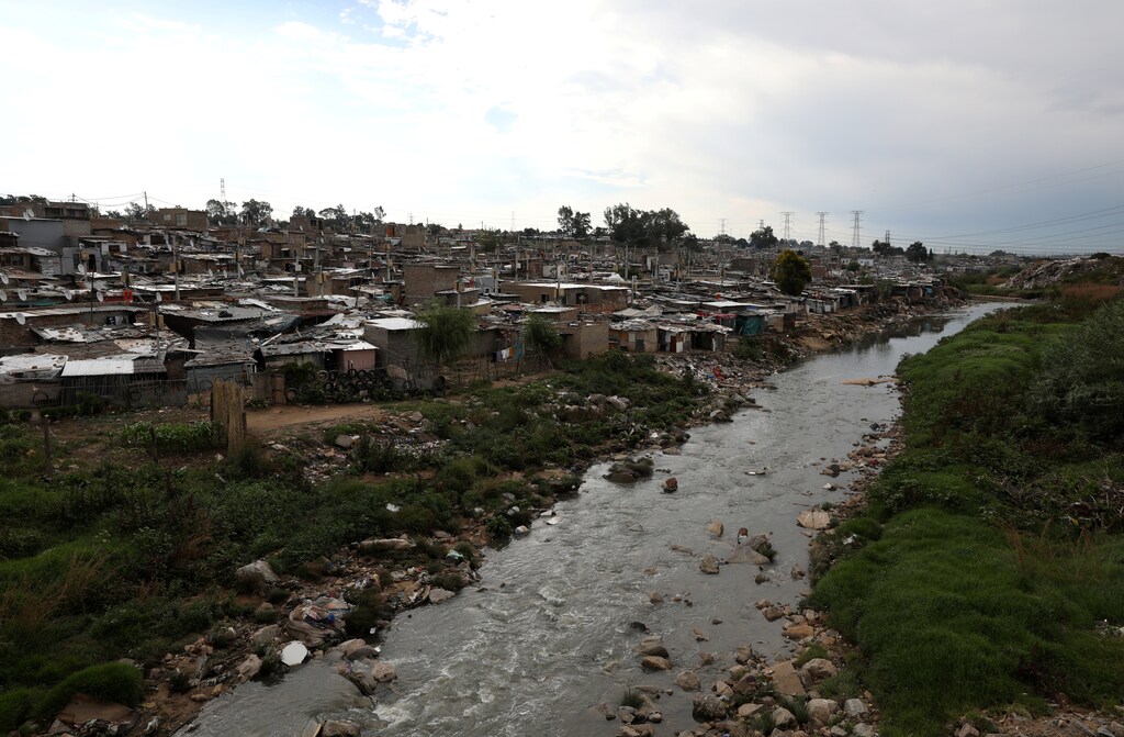 Shacks are seen along Jukskei river in Alexandra township, Johannesburg, South Africa