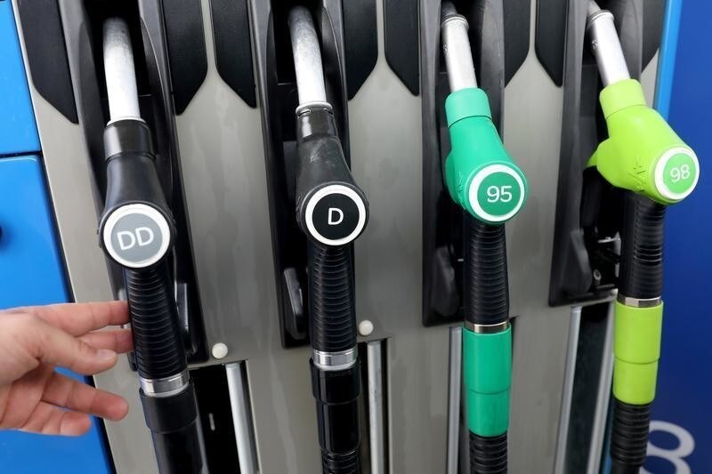 A man picks up a fuel nozzle at a petrol station in Madrid, Spain, May 29, 2018.