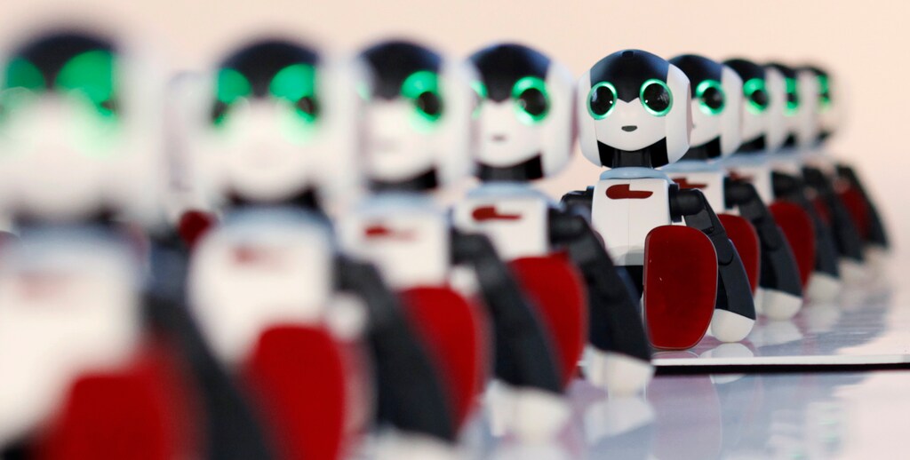 A hundred humanoid communication robots called Robi sit before a dance performance dance during a promotional event called 100 Robi, for the Weekly Robi Magazine, in Tokyo January 20, 2015. The 34cm-tall (13.4-inch) robot, designed by Tomotaka Takahashi, chief executive officer of Robo Garage Co and project associate professor of Research Centre for Advanced Science and Technology at the University of Tokyo, is able to speak, walk and dance. The weekly magazine comes with parts of the robot, which allows buyers to have a fully assembled Robi after 70 issues. REUTERS/Yuya Shino (JAPAN - Tags: SOCIETY BUSINESS)