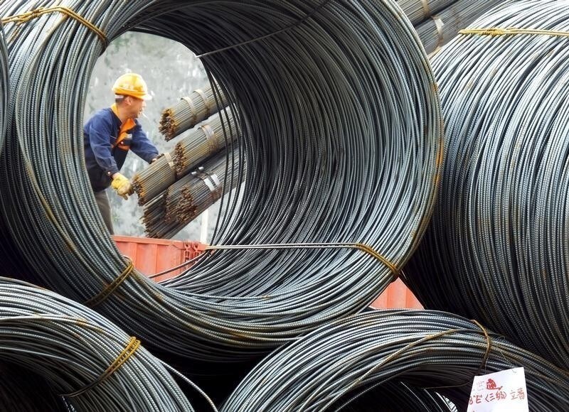 An employee unloads steel products at a market in Yichang, Hubei Province, China, April 7, 2016.