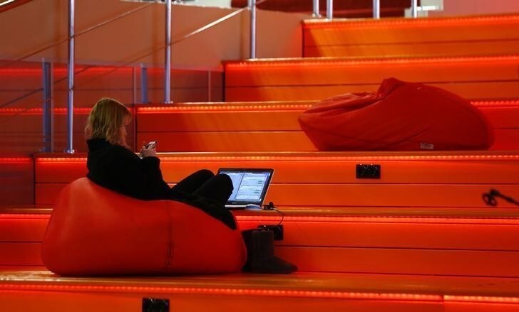 A woman with a laptop is seen in Hi-Tech Park Belarus building in Minsk, Belarus March 17, 2016. To match Insight BELARUS-TECH/ REUTERS/Vasily Fedosenko