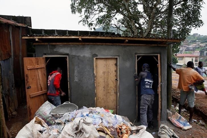 Men work on public toilets at a camp for internally displaced people in Regent, Sierra Leone August 19, 2017. REUTERS/Afolabi Sotunde