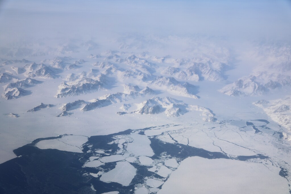 Broken up sea ice is seen from the window of a NASA Gulfstream III flight to support the Oceans Melting Greenland (OMG) research mission above the east coast of Greenland, March 12, 2018. REUTERS/Lucas Jackson - RC149DC88E20